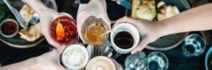 group of friends toasting with different drinks